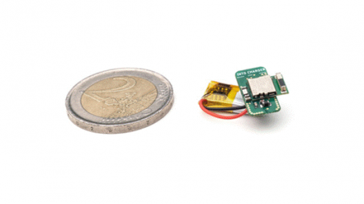 A prototype of IoSA’s ultralight, ultra-low power, highly accurate proximity tracker next to a 2 euro coin.  